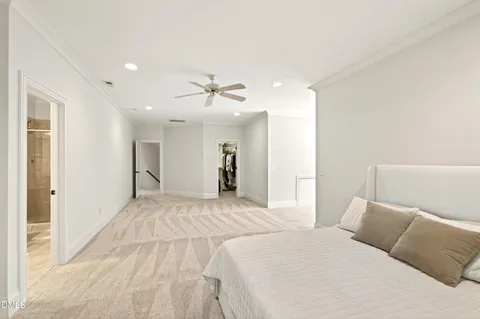 an empty room with windows and ceiling fan