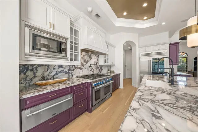 a large kitchen with granite countertop a lot of counter space and a sink