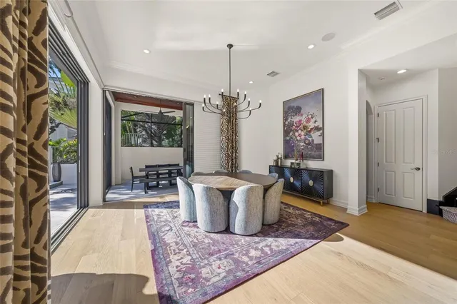 a living room with furniture a chandelier and a rug