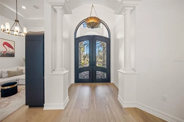 a living room with furniture chandelier and fireplace