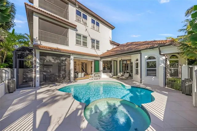 an aerial view of a city with lots of residential buildings ocean and mountain view in back
