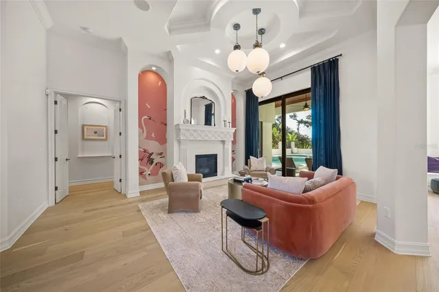a living room with furniture and a chandelier