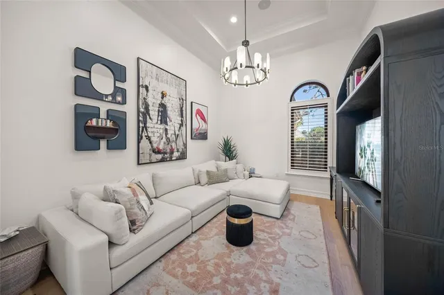 a kitchen with stainless steel appliances kitchen island granite countertop a table chairs in it and wooden floors