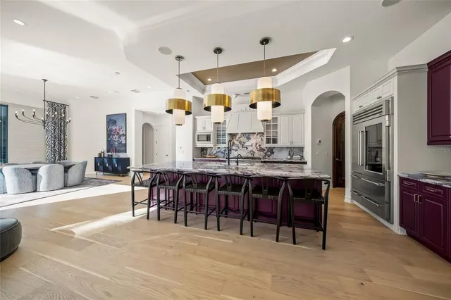 a kitchen with stainless steel appliances granite countertop a stove and cabinets