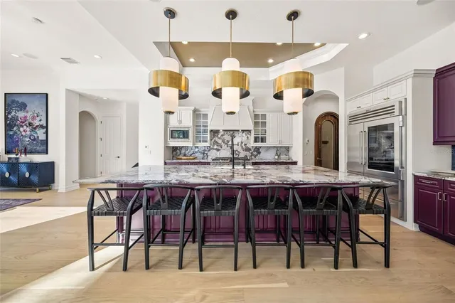 a large kitchen with stainless steel appliances granite countertop a stove and a center island