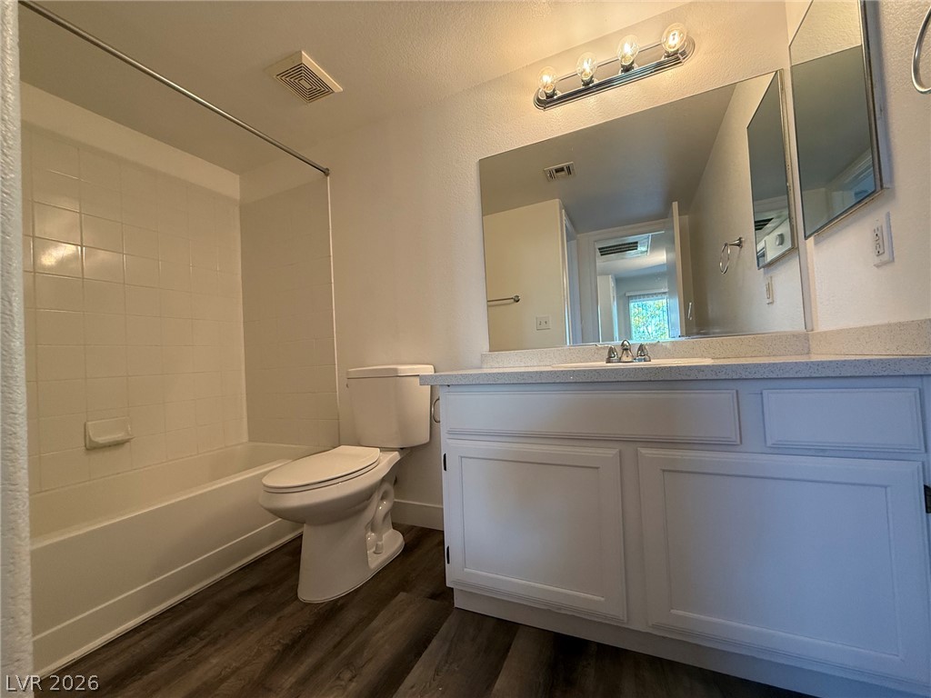 7255 West Sunset Road, Unit 2149 Las Vegas, NV 89113 - Photo 23 of 28 Modern bath features a single vanity with stone counters and vinyl plank flooring for easy maintenance.