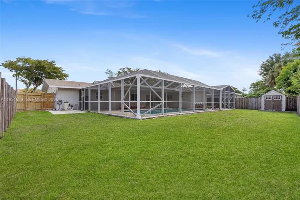 a view of a house with a backyard