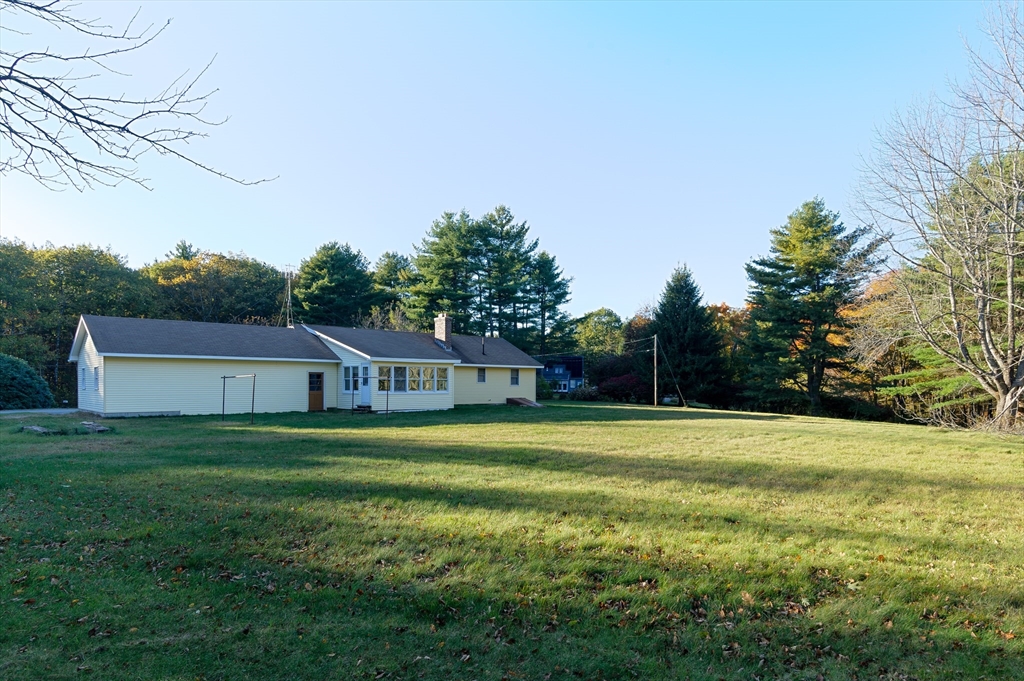 85 Marsh Road Barre, MA 01005 - Photo 5 of 27 a front view of a house with a yard and trees