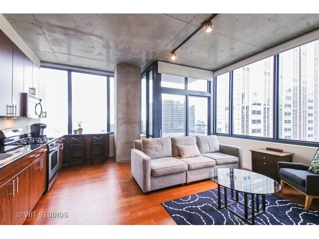 235 West Van Buren Street, Unit 3315 Chicago, IL 60607 - Photo 4 of 23 a living room with furniture and a large window