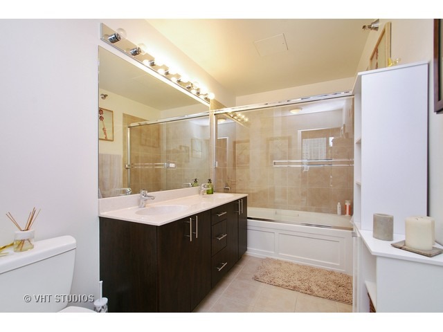 235 West Van Buren Street, Unit 3315 Chicago, IL 60607 - Photo 7 of 23 a bathroom with a sink a toilet and shower