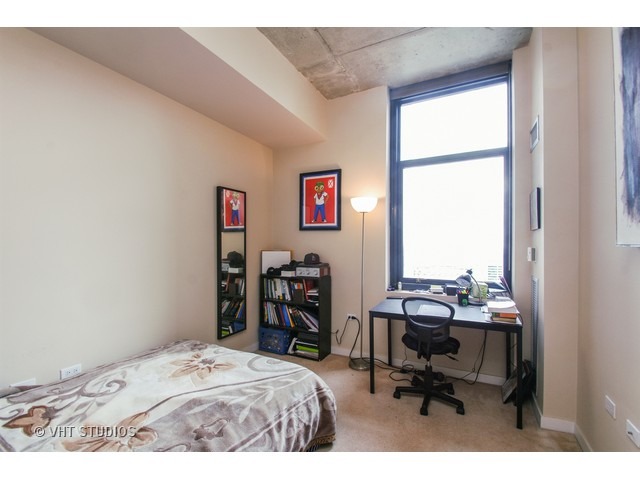 235 West Van Buren Street, Unit 3315 Chicago, IL 60607 - Photo 8 of 23 a bedroom with a bed a computer on desk and a window