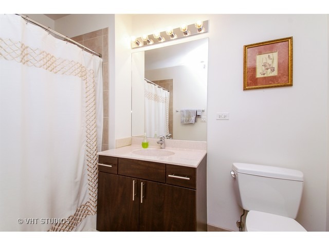 235 West Van Buren Street, Unit 3315 Chicago, IL 60607 - Photo 9 of 23 a bathroom with a toilet a sink and mirror