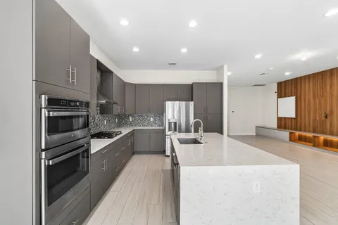 a large kitchen with stainless steel appliances lots of counter top space
