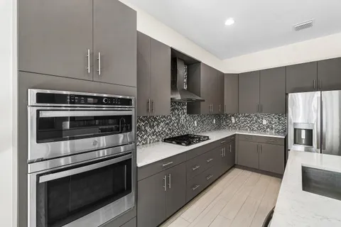 a kitchen with stainless steel appliances and white cabinets
