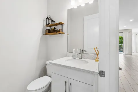 a bathroom with a toilet sink and mirror