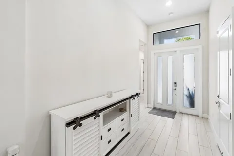 a view of a hallway with wooden floor