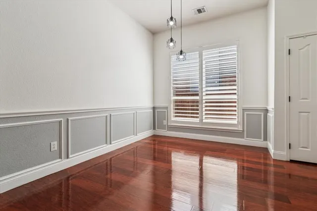 a view of an empty room with window and closet area