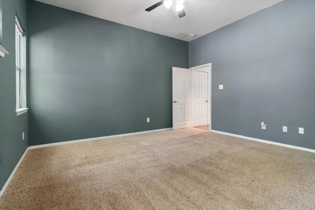 a en suite bathroom with a double vanity sink a toilet and a mirror