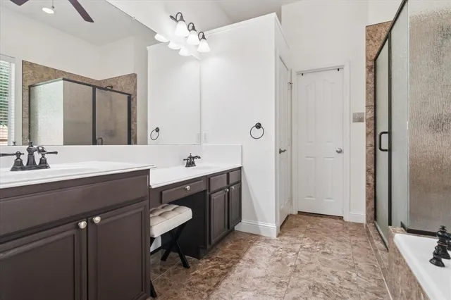 a bathroom with a tub a sink and a mirror