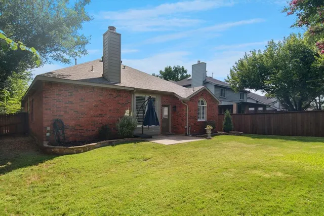 a view of garden with wooden fence
