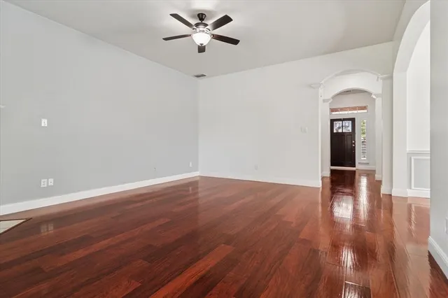 a view of empty room with wooden floor