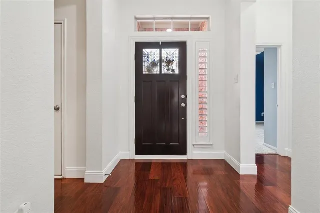 a view of an entryway with wooden floor