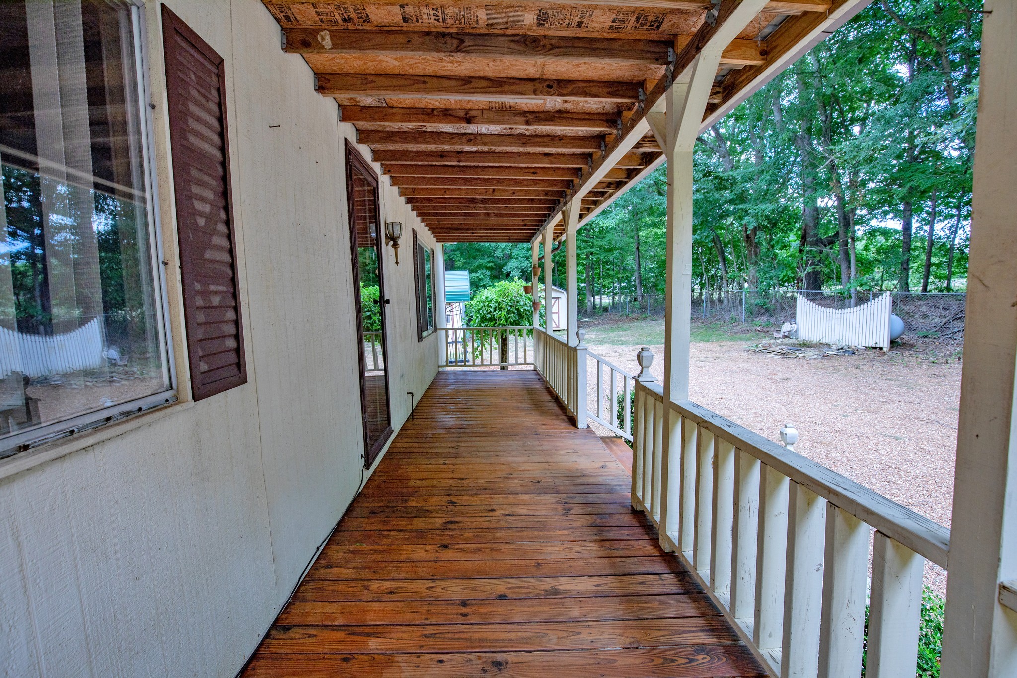 7498 Swift Road Greenbrier, TN 37073 - Photo 16 of 69 a view of a porch with wooden floor and stairs