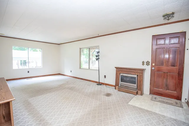 a kitchen with a sink a stove a window and cabinets