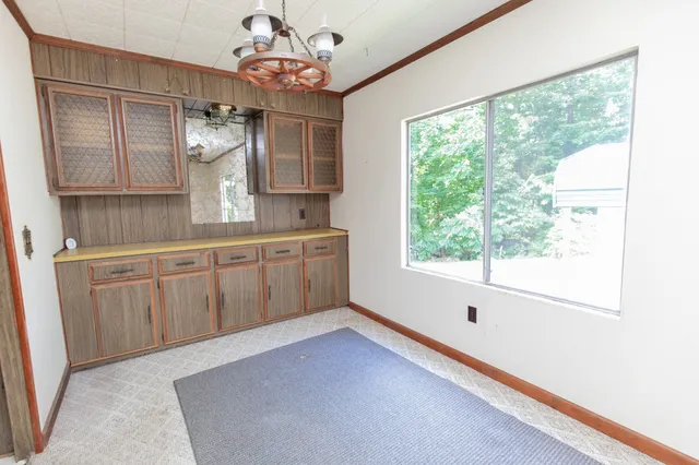 a view of a livingroom with a fireplace and cabinet