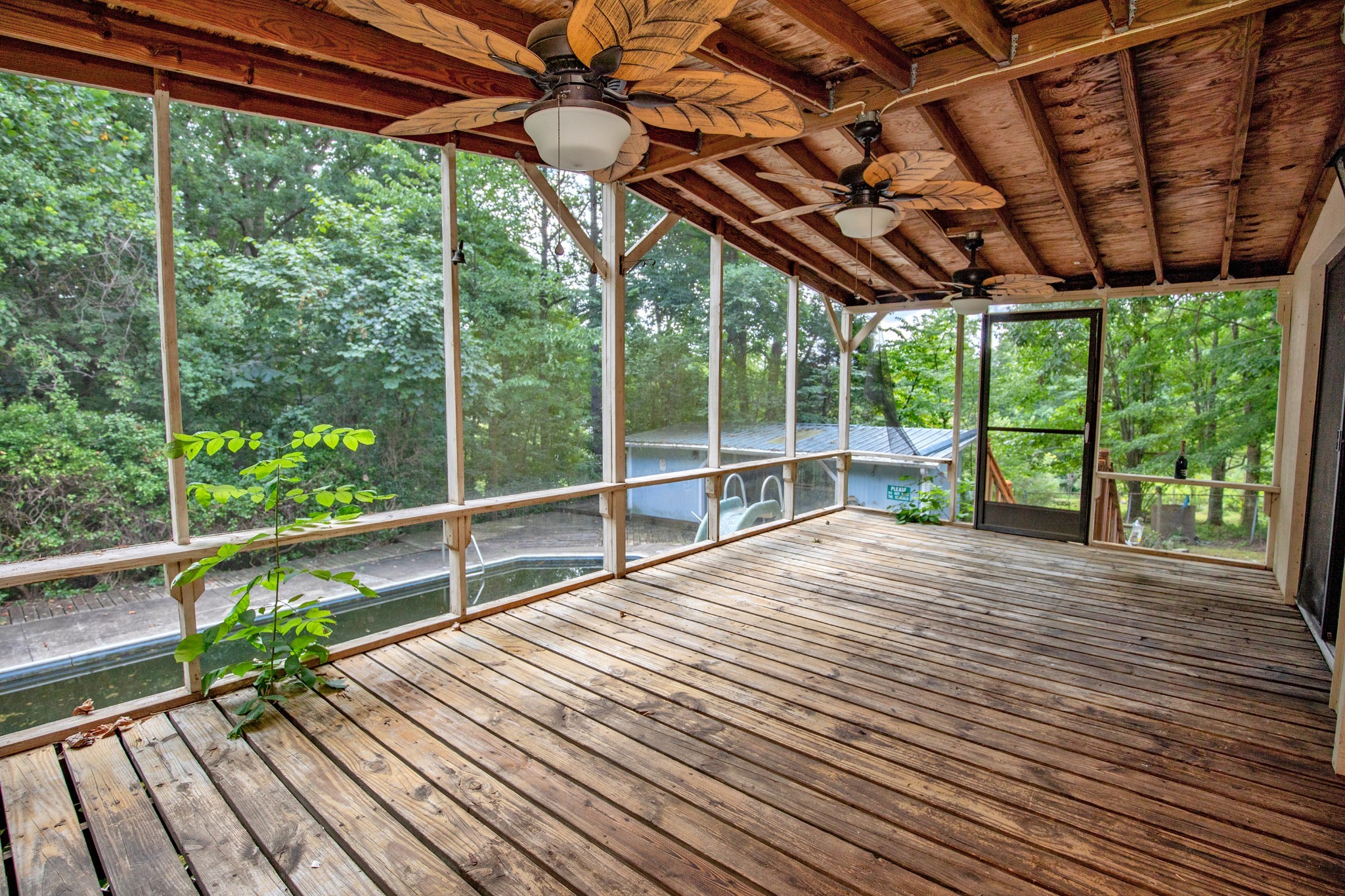 7498 Swift Road Greenbrier, TN 37073 - Photo 34 of 69 a view of a deck with wooden floor and roof with a garden view