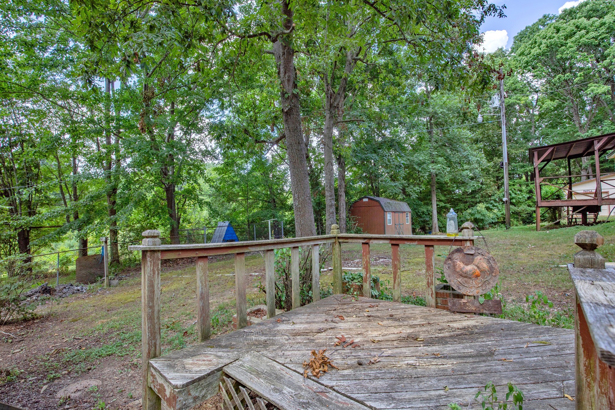 7498 Swift Road Greenbrier, TN 37073 - Photo 38 of 69 a backyard of a house with table and chairs potted plants and large tree
