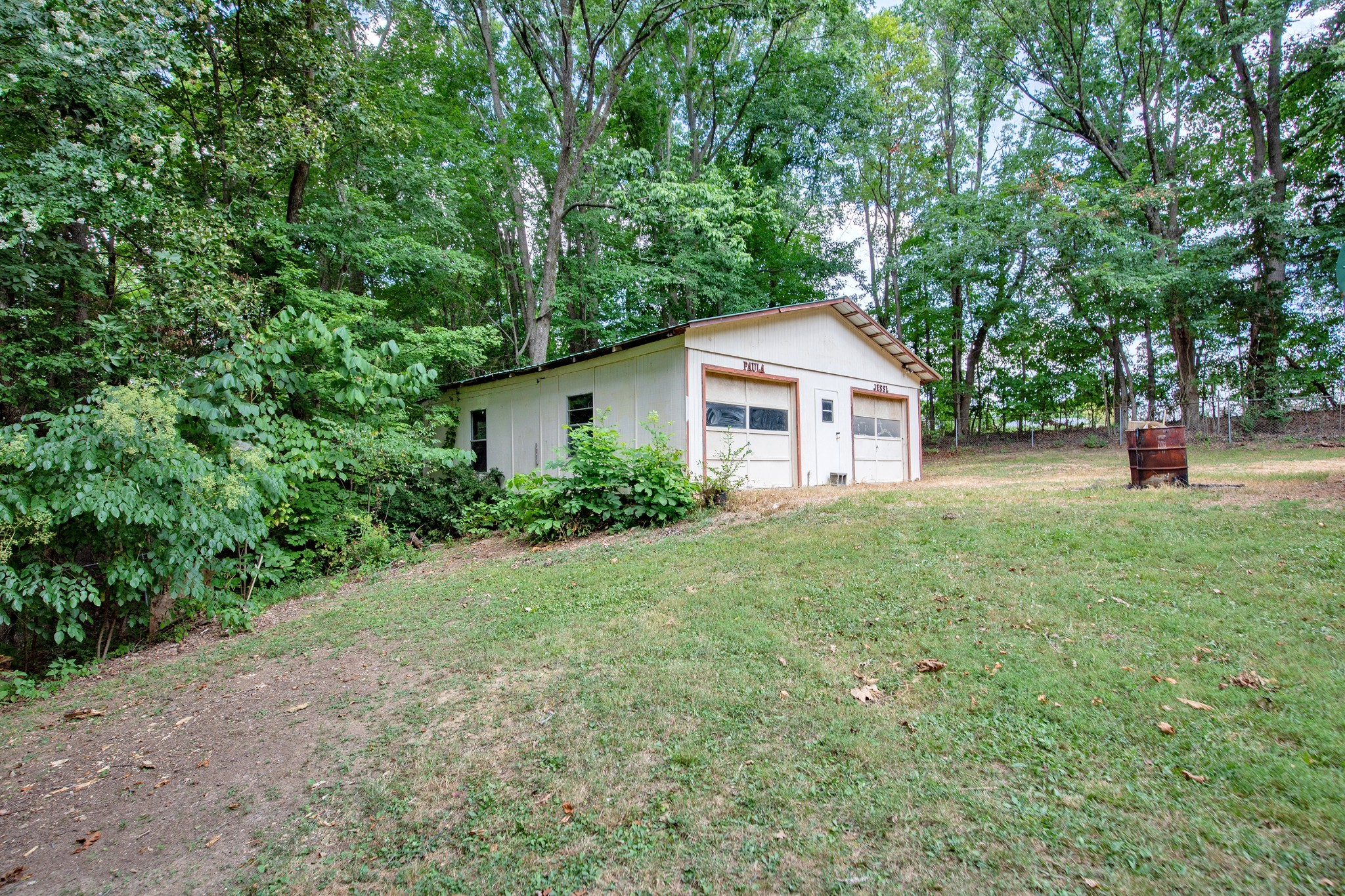 7498 Swift Road Greenbrier, TN 37073 - Photo 49 of 69 a front view of a house with a yard and trees