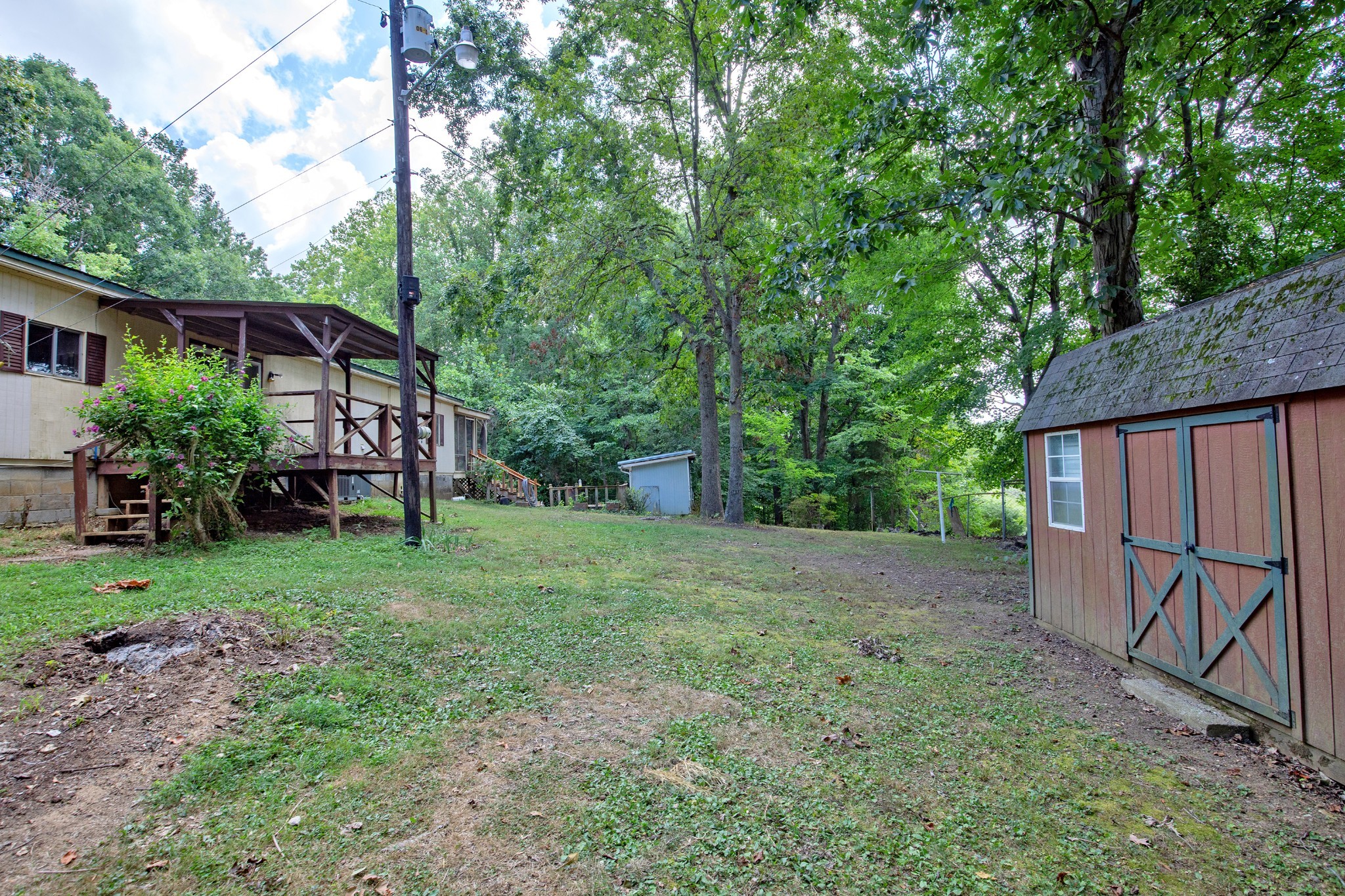 7498 Swift Road Greenbrier, TN 37073 - Photo 52 of 69 a view of backyard with potted plants and large tree
