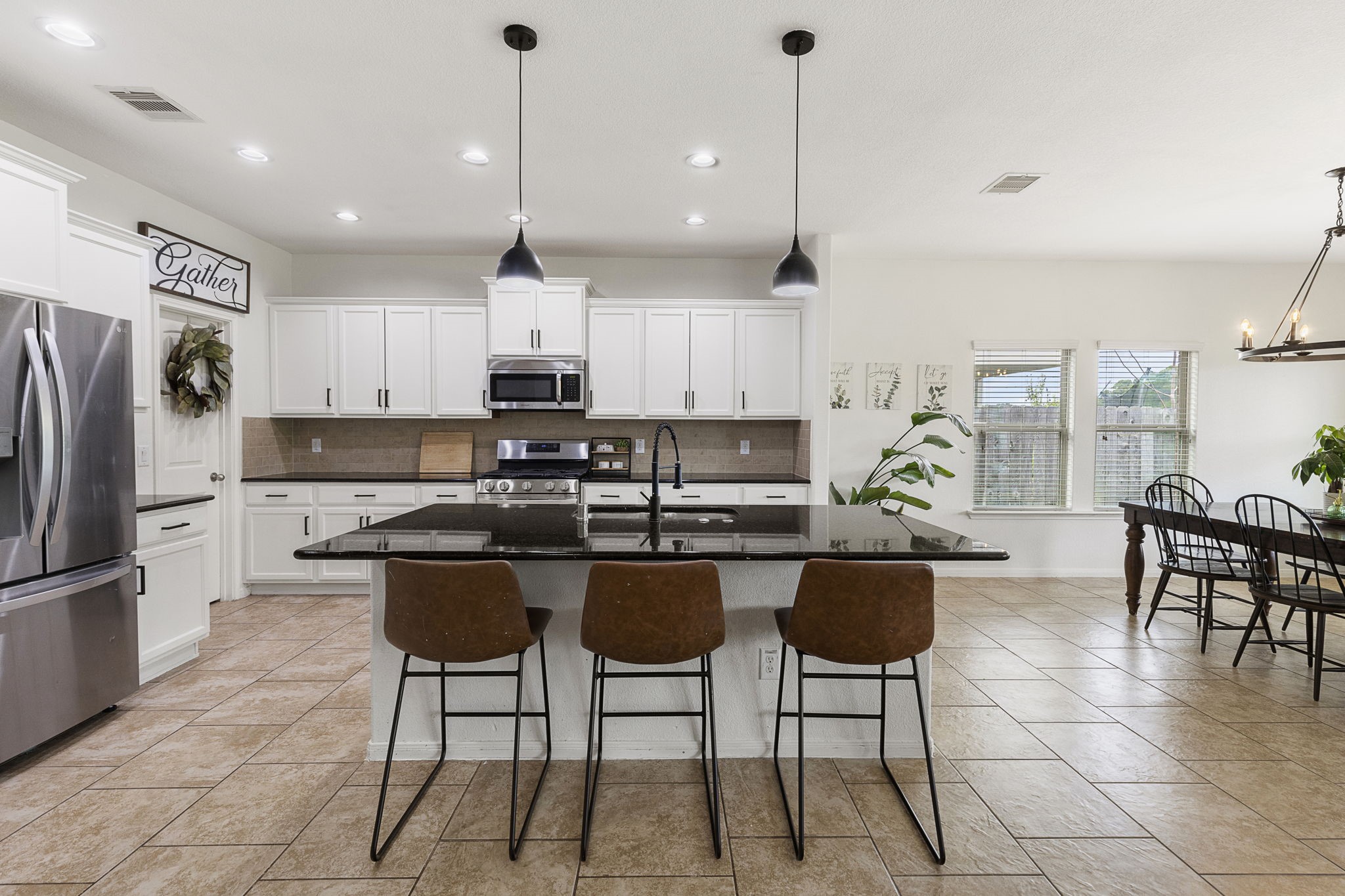 22810 Dale River Road Tomball, TX 77375 - Photo 8 of 44 Oversized island with easy eat-in option plus tons of additional counter and cabinet space in this large kitchen.