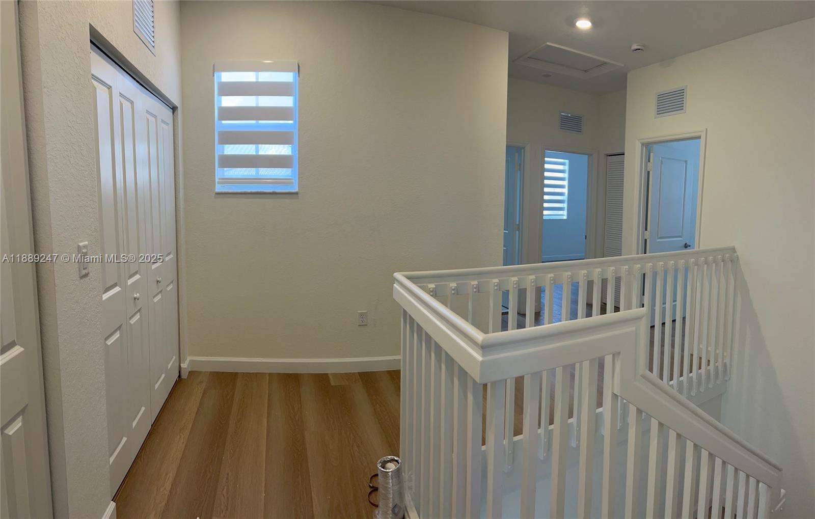 2651 Southeast 24th Drive Homestead, FL 33035 - Photo 13 of 40 a view of a hallway and a livingroom with windows