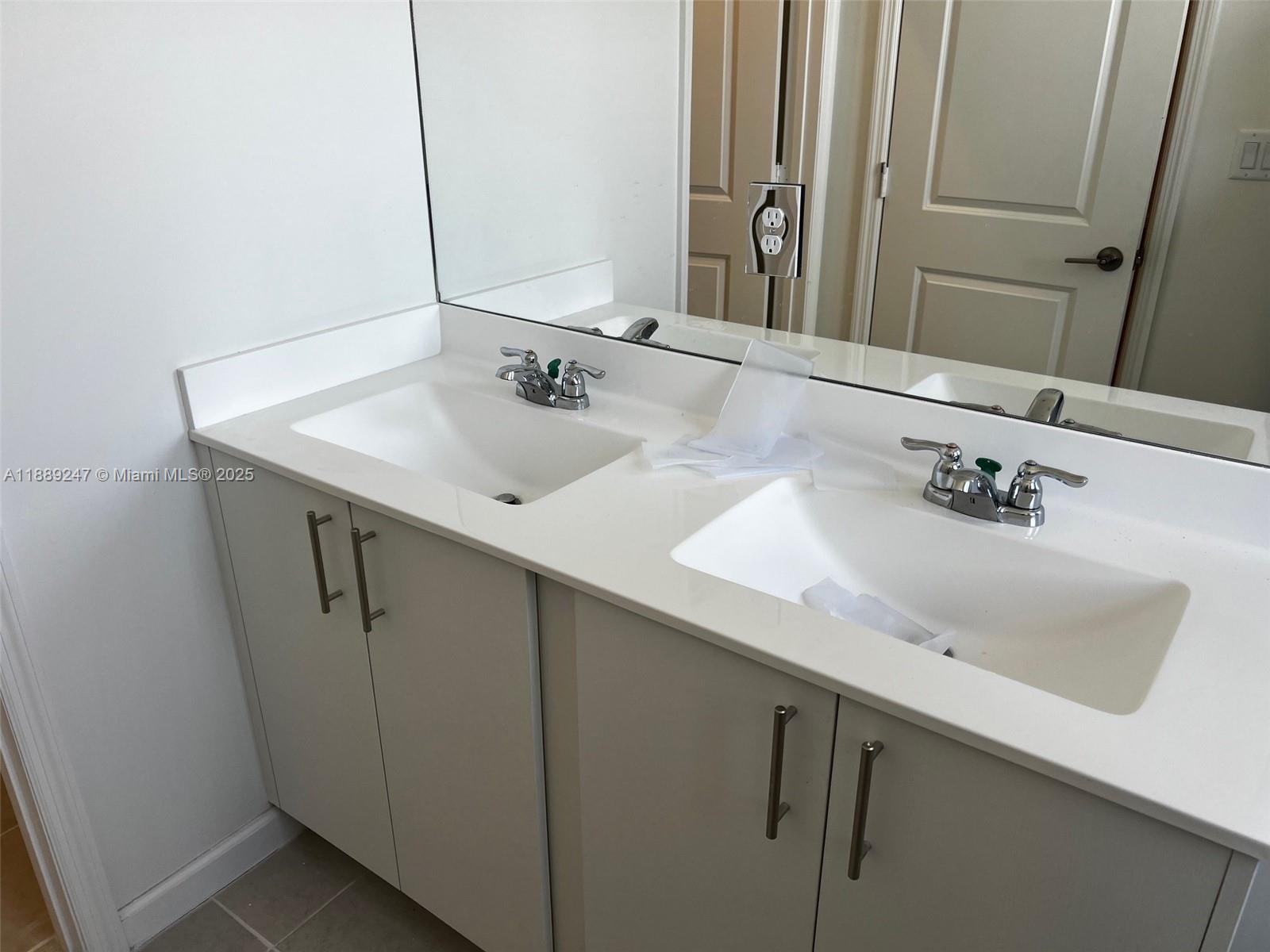 2651 Southeast 24th Drive Homestead, FL 33035 - Photo 22 of 40 a bathroom with a sink and a mirror