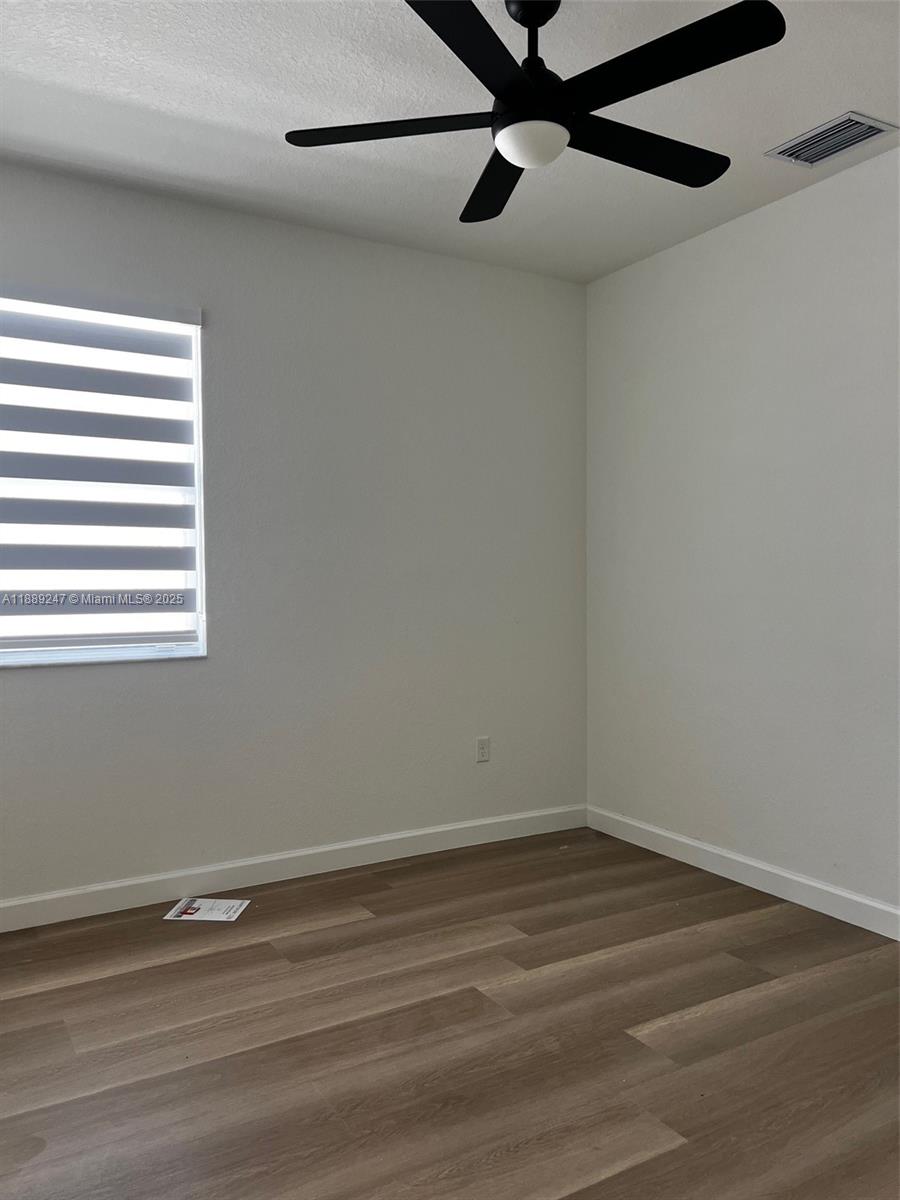 2651 Southeast 24th Drive Homestead, FL 33035 - Photo 26 of 40 a view of a small space with wooden floor a ceiling fan