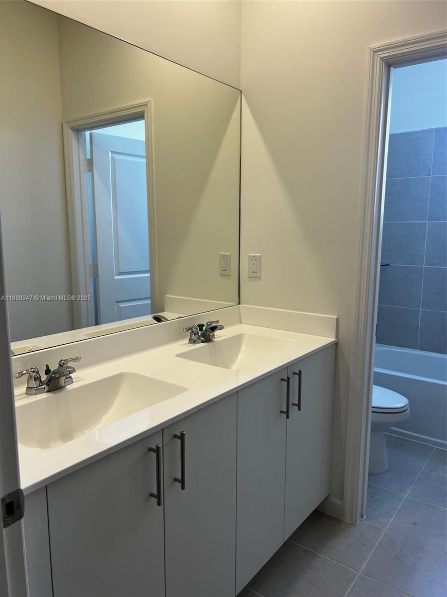 2651 Southeast 24th Drive Homestead, FL 33035 - Photo 27 of 40 a bathroom with a sink and a mirror