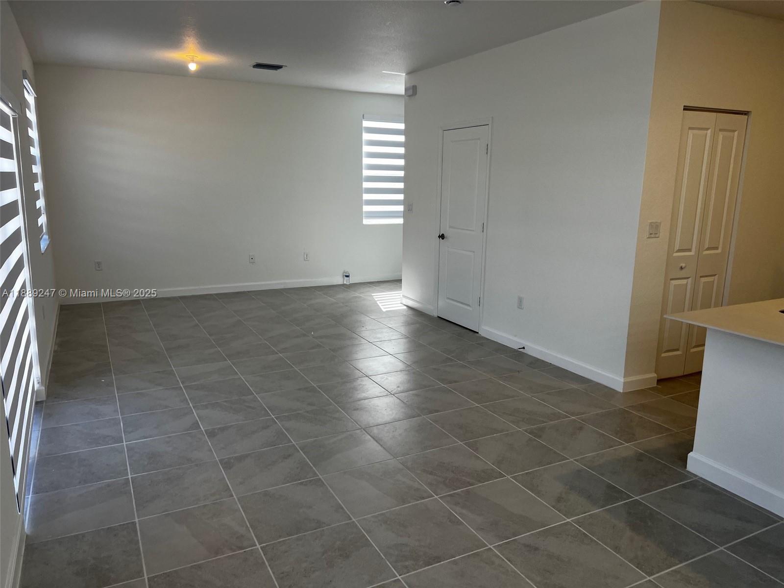 2651 Southeast 24th Drive Homestead, FL 33035 - Photo 5 of 40 a view of an empty room with a window