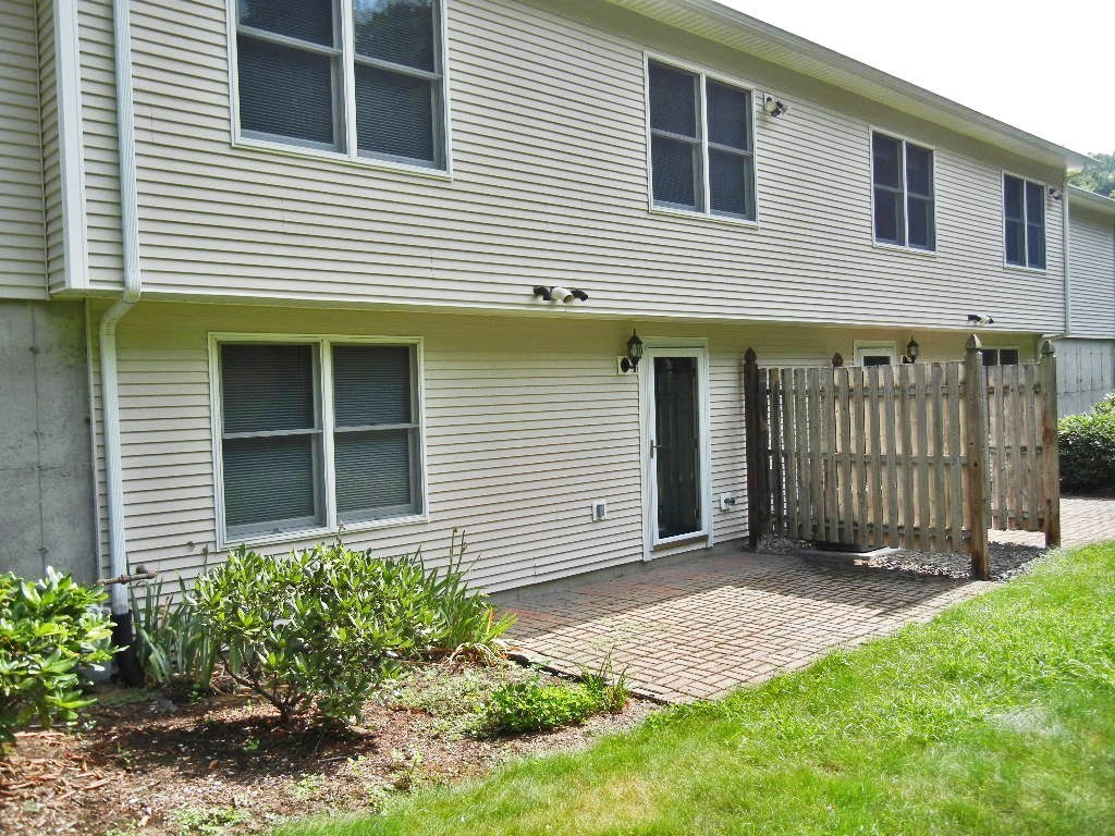 399 Bridge Road, Unit E Northampton, MA 01062 - Photo 17 of 17 a front view of a house with a garden