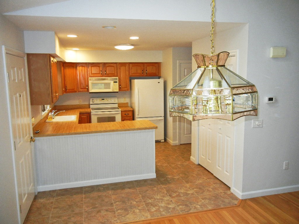 399 Bridge Road, Unit E Northampton, MA 01062 - Photo 3 of 17 a room with wooden cabinets