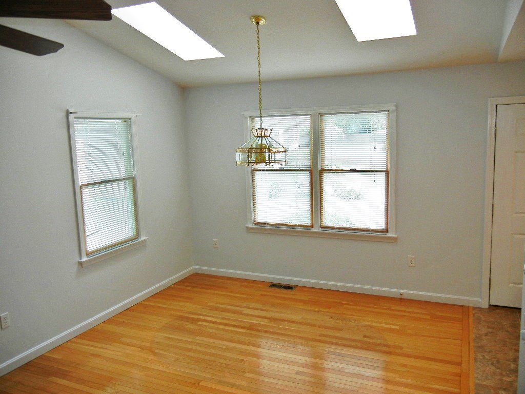 399 Bridge Road, Unit E Northampton, MA 01062 - Photo 4 of 17 a view of empty room with wooden floor and fan