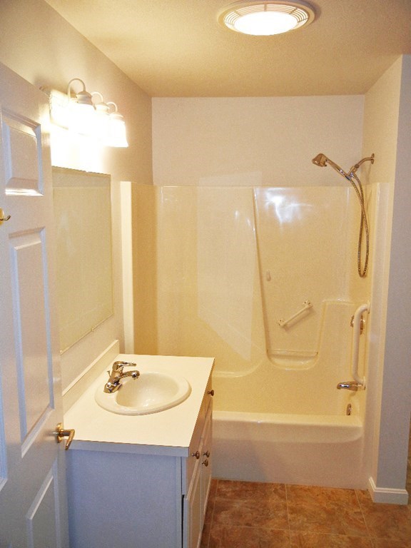399 Bridge Road, Unit E Northampton, MA 01062 - Photo 10 of 17 a bathroom with a sink and mirror with bathtub