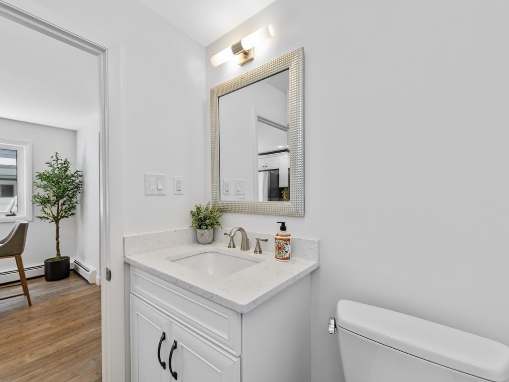 18 R Polk Street Boston, MA 02129 - Photo 10 of 19 a bathroom with a sink toilet and a mirror