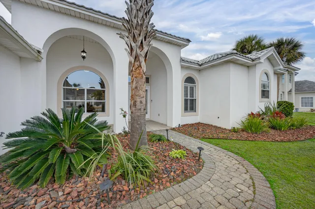 a view of an empty room with wooden floor and a large window