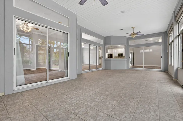 a kitchen with a refrigerator a sink cabinets and wooden floor
