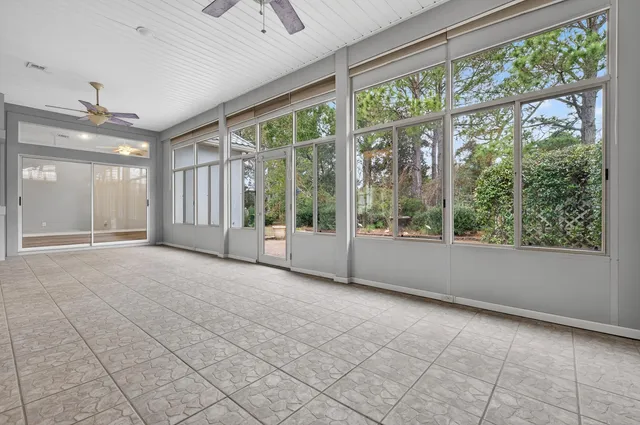 a kitchen with a white cabinets and chandelier