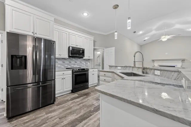 a view of kitchen with cabinets and wooden floor