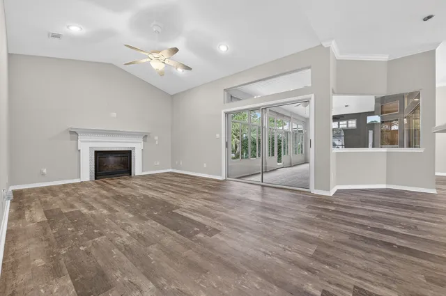 a spacious bathroom with a granite countertop sink mirror and bathtub