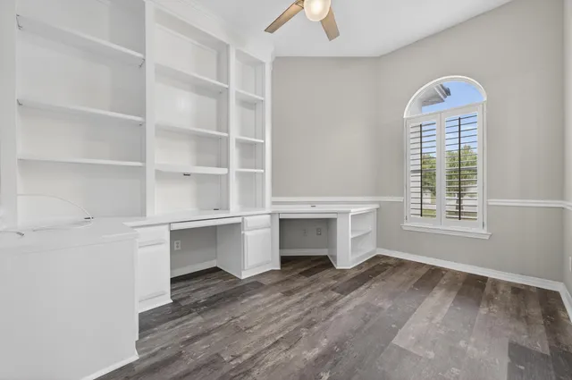 a bathroom with a granite countertop toilet a sink and a mirror